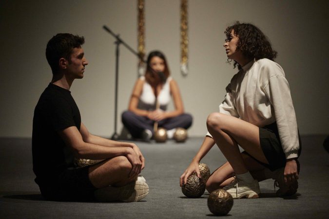 Hiçbir bedel, hiçbir koşul istemeden – Undoubtedly, I am a high-frequency energy, performed by Kardelen Savcı, Ahmet Berk Tuzcu, and Bengisu Üstay with Instrument I (Sevgi and Bengisu) (2022). Istanbul Biennale, 2022. Performance made in collaboration with Bengisu Üstay. Courtesy of the artist and Michael Lett. Photo: David Levene.